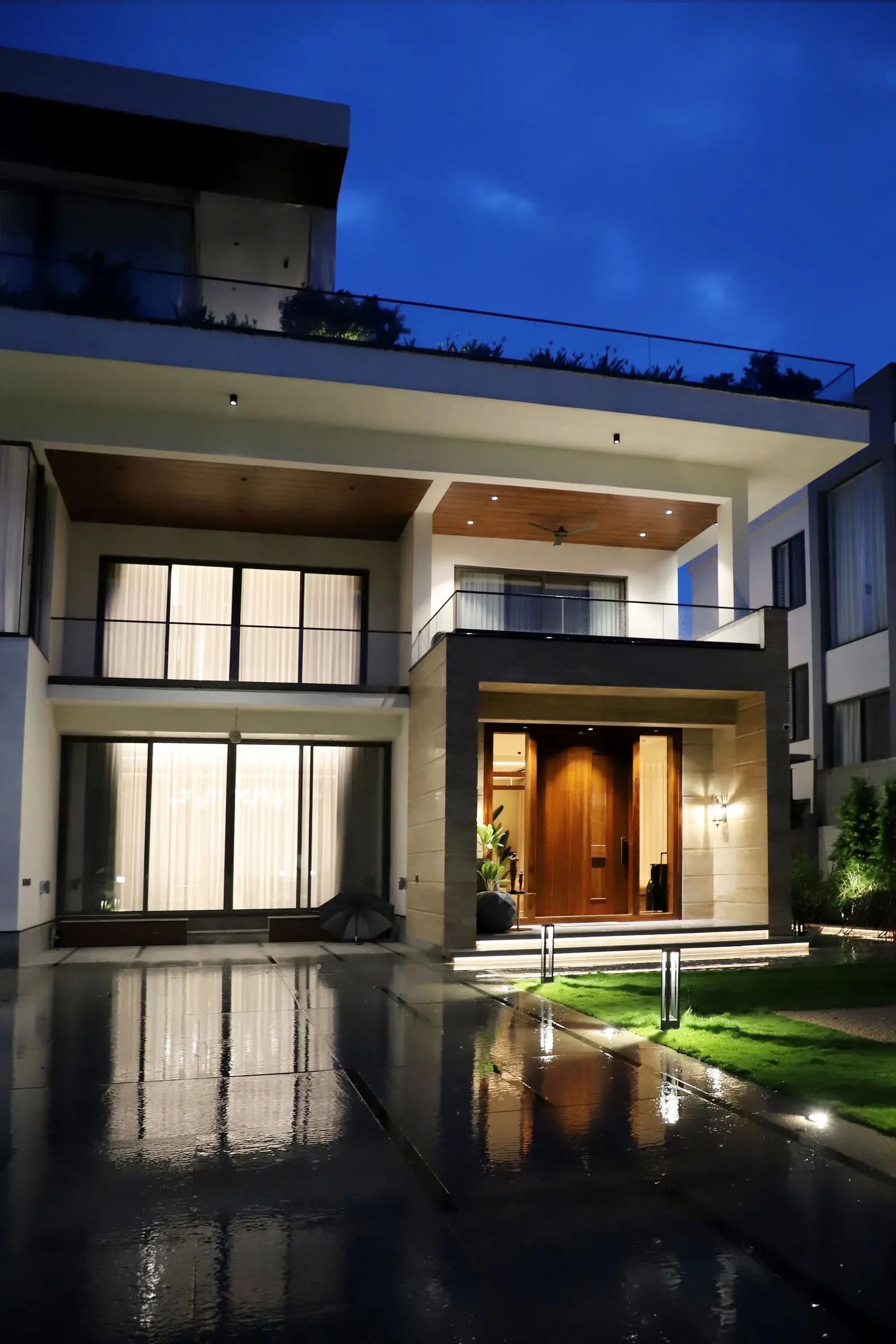 A modern villa at night, lit from within